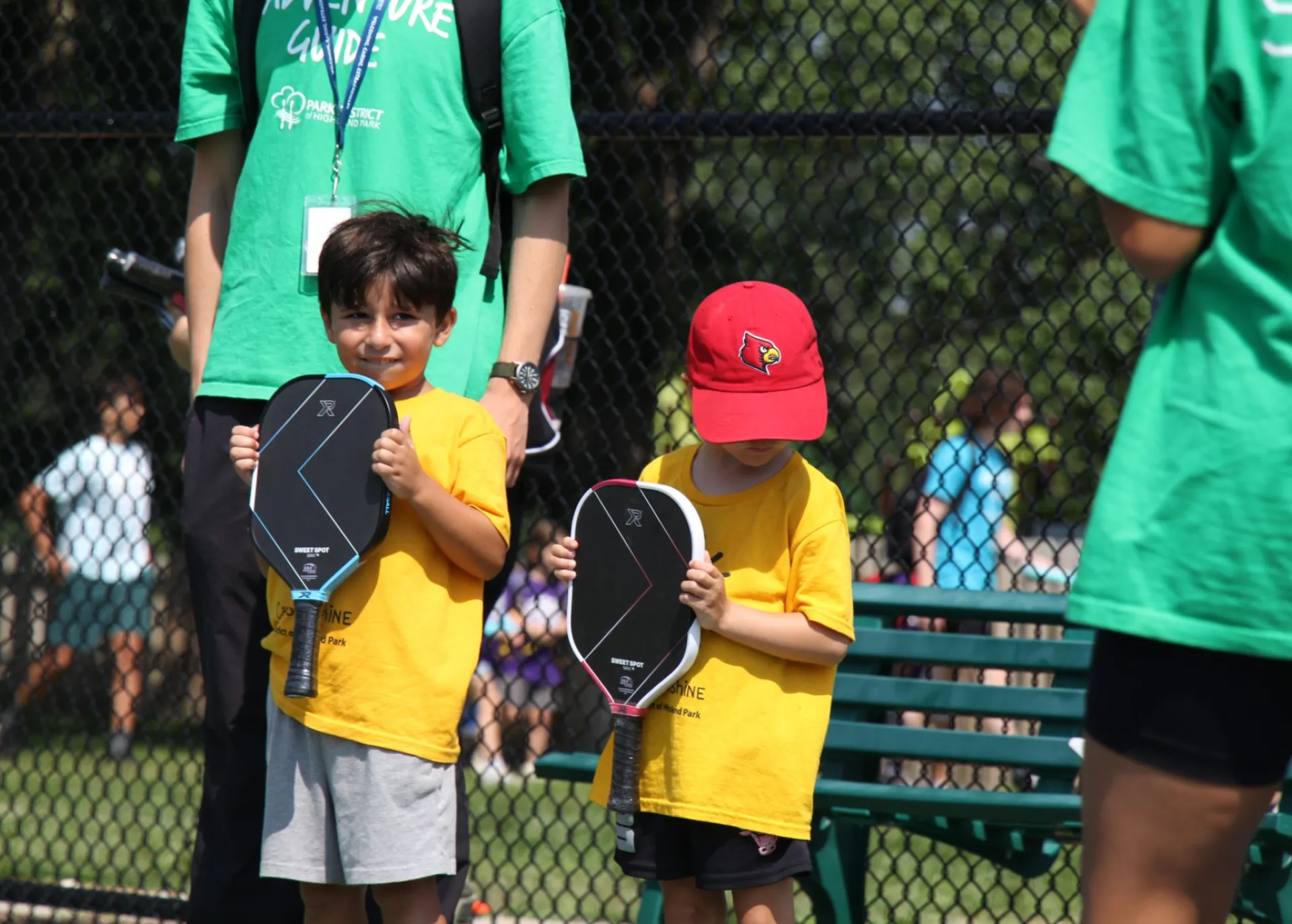 Child holding pickleball paddle at lesson